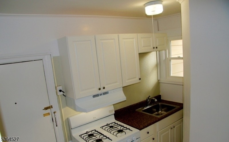 76 Grove Street Montclair, NJ 07042 - Photo 8 of 15 a bathroom with a granite countertop sink and a mirror