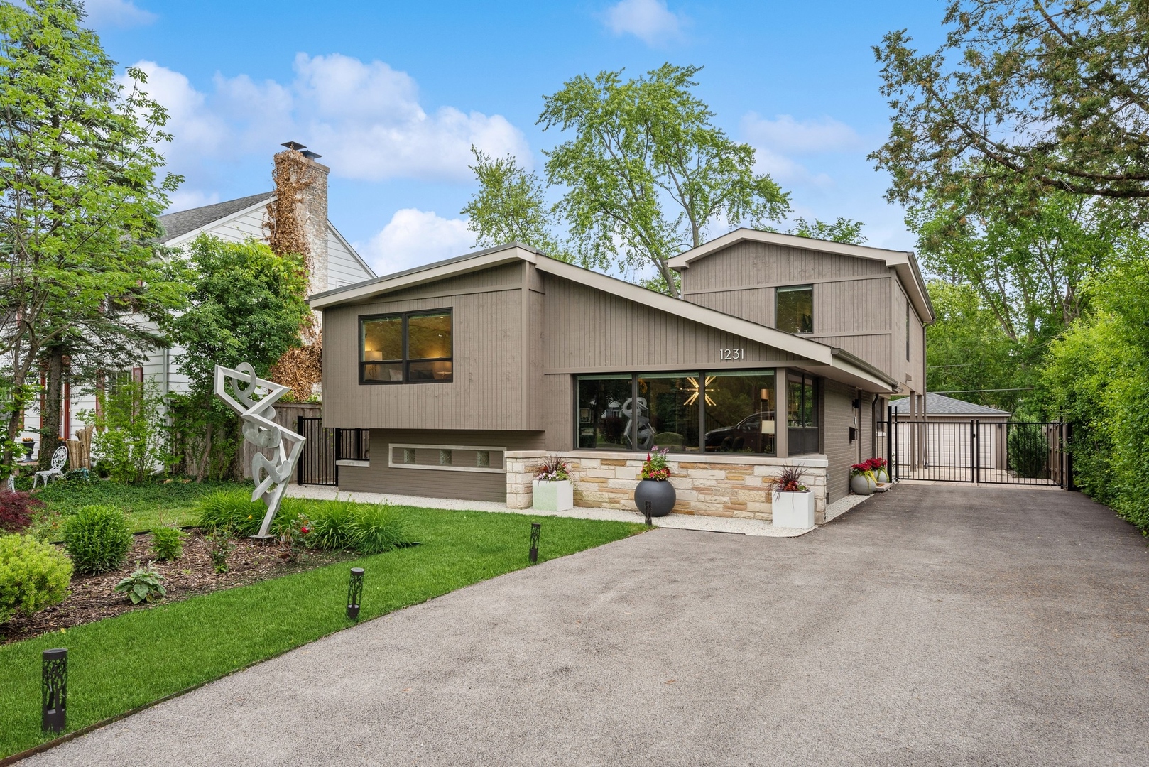a view of a house with a yard and large tree
