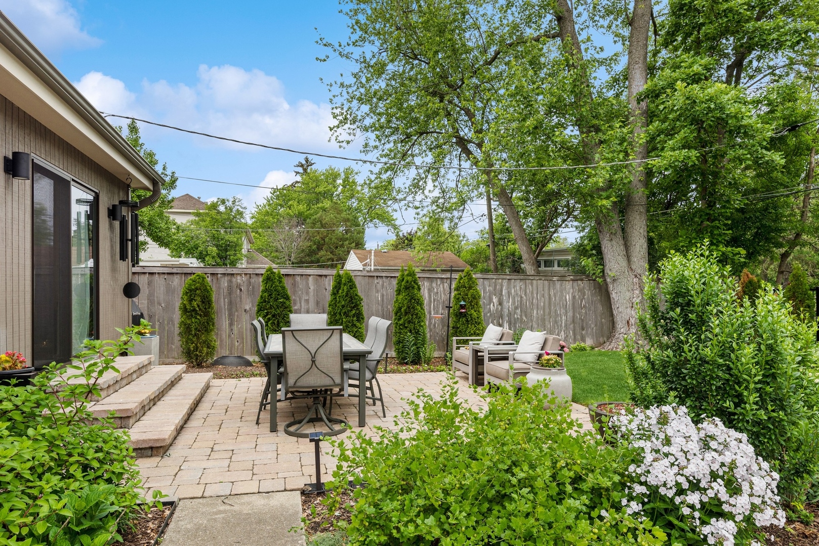 1231 Ridge Road Highland Park, IL 60035 - Photo 22 of 30 a view of a patio with table and chairs potted plants and large tree