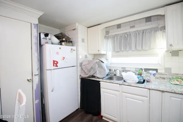a white refrigerator freezer sitting inside of a kitchen