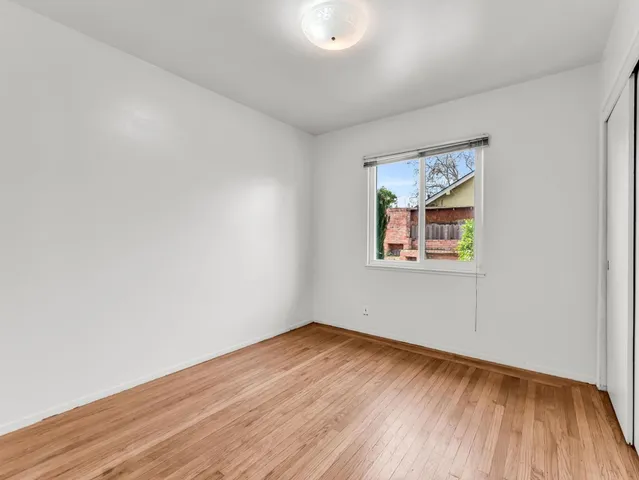 a view of a room with wooden floor and window