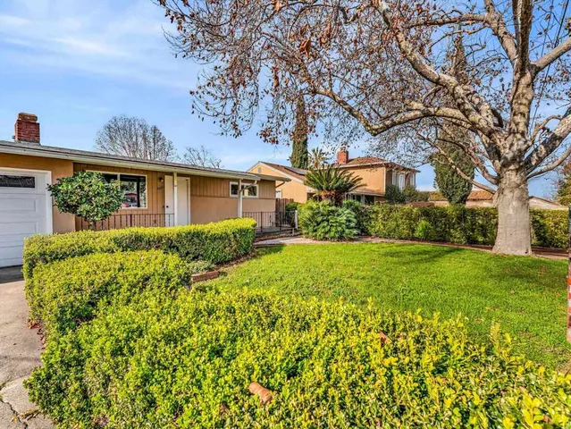 a view of a house with garden and yard