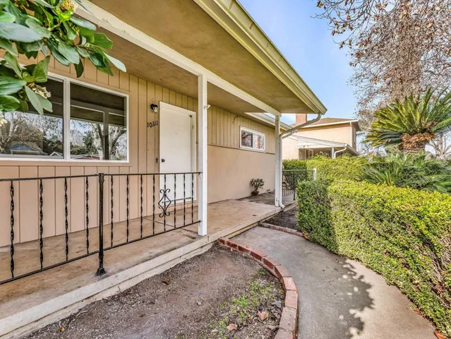 a view of a house with a small yard and plants