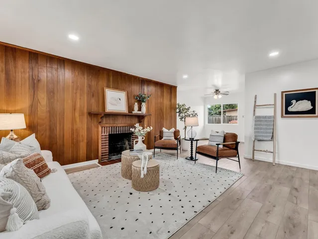 a living room with furniture and a fireplace