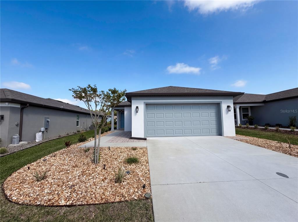 a view of a house with a yard and garage