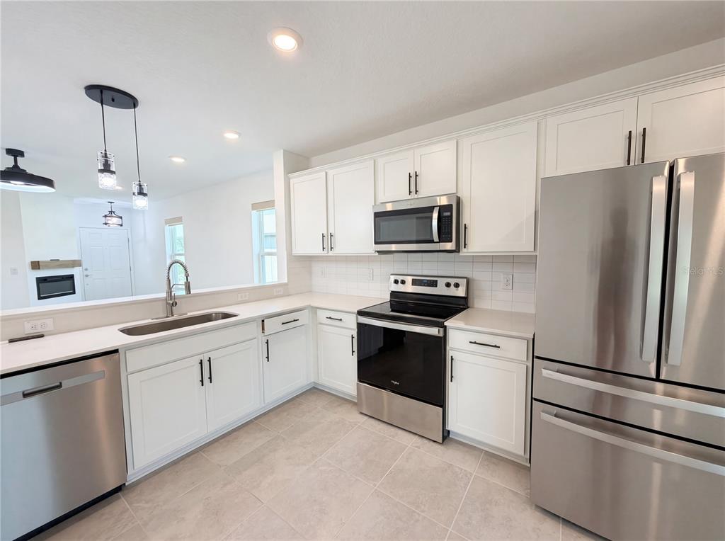 8359 Southwest 54th Street Ocala, FL 34481 - Photo 12 of 26 a kitchen with stainless steel appliances and refrigerator