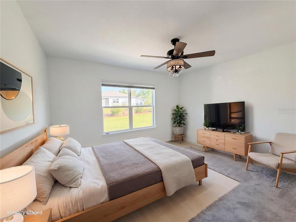 8359 Southwest 54th Street Ocala, FL 34481 - Photo 15 of 26 a bedroom with a bed and a flat screen tv