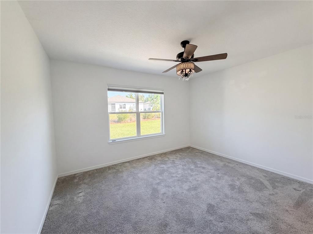 8359 Southwest 54th Street Ocala, FL 34481 - Photo 16 of 26 an empty room with windows and ceiling fan