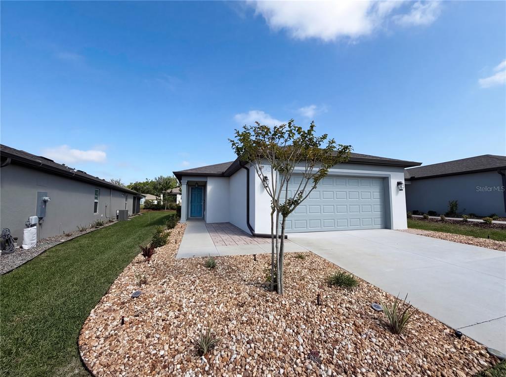 8359 Southwest 54th Street Ocala, FL 34481 - Photo 2 of 26 a front view of a house with a yard