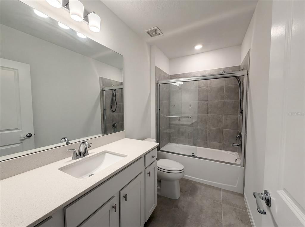 8359 Southwest 54th Street Ocala, FL 34481 - Photo 22 of 26 a bathroom with a bathtub shower sink mirror and toilet