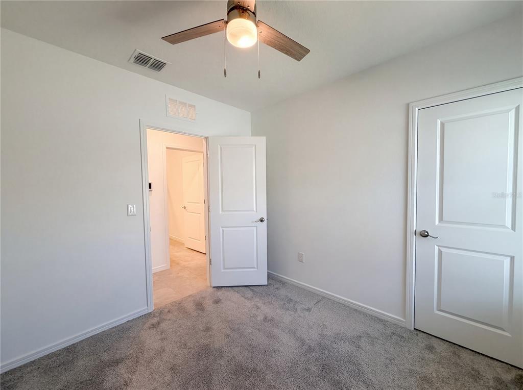 8359 Southwest 54th Street Ocala, FL 34481 - Photo 24 of 26 an empty room with closet and a chandelier fan