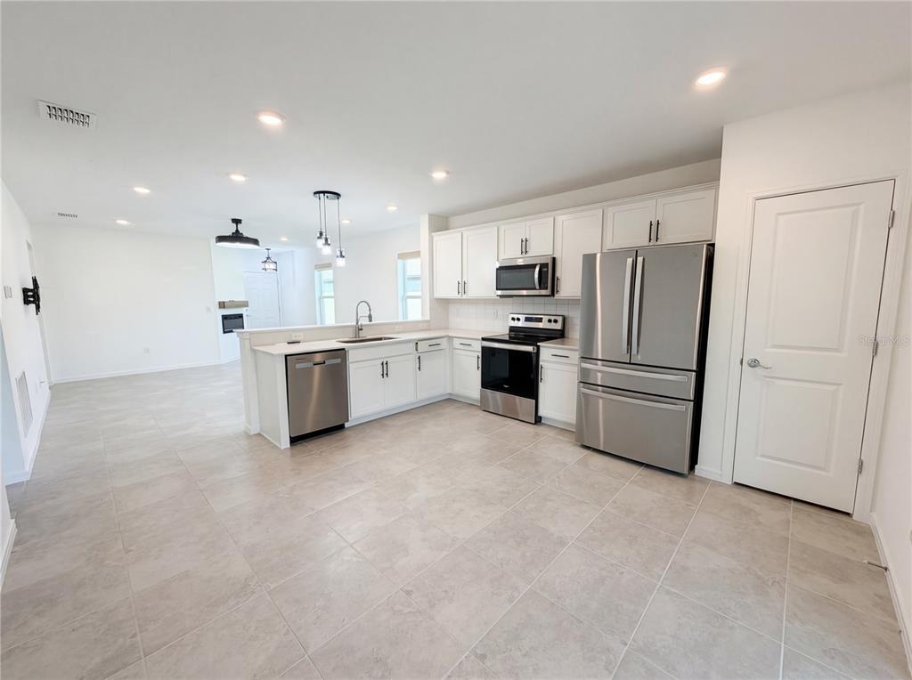 8359 Southwest 54th Street Ocala, FL 34481 - Photo 8 of 26 a kitchen with stainless steel appliances a refrigerator sink and stove