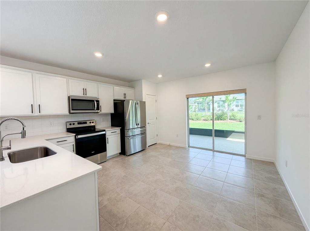 8359 Southwest 54th Street Ocala, FL 34481 - Photo 10 of 26 a kitchen with stainless steel appliances granite countertop a refrigerator sink and stove