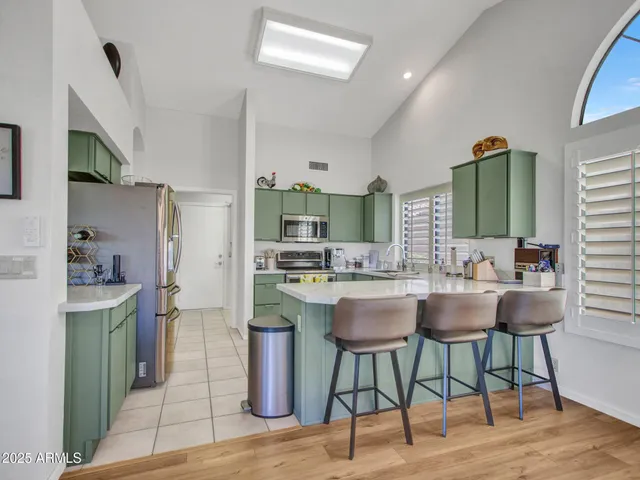 a kitchen with stainless steel appliances wooden cabinets a stove and a sink
