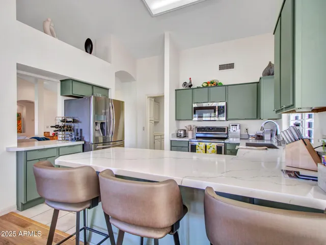 a kitchen with a sink cabinets and wooden floor