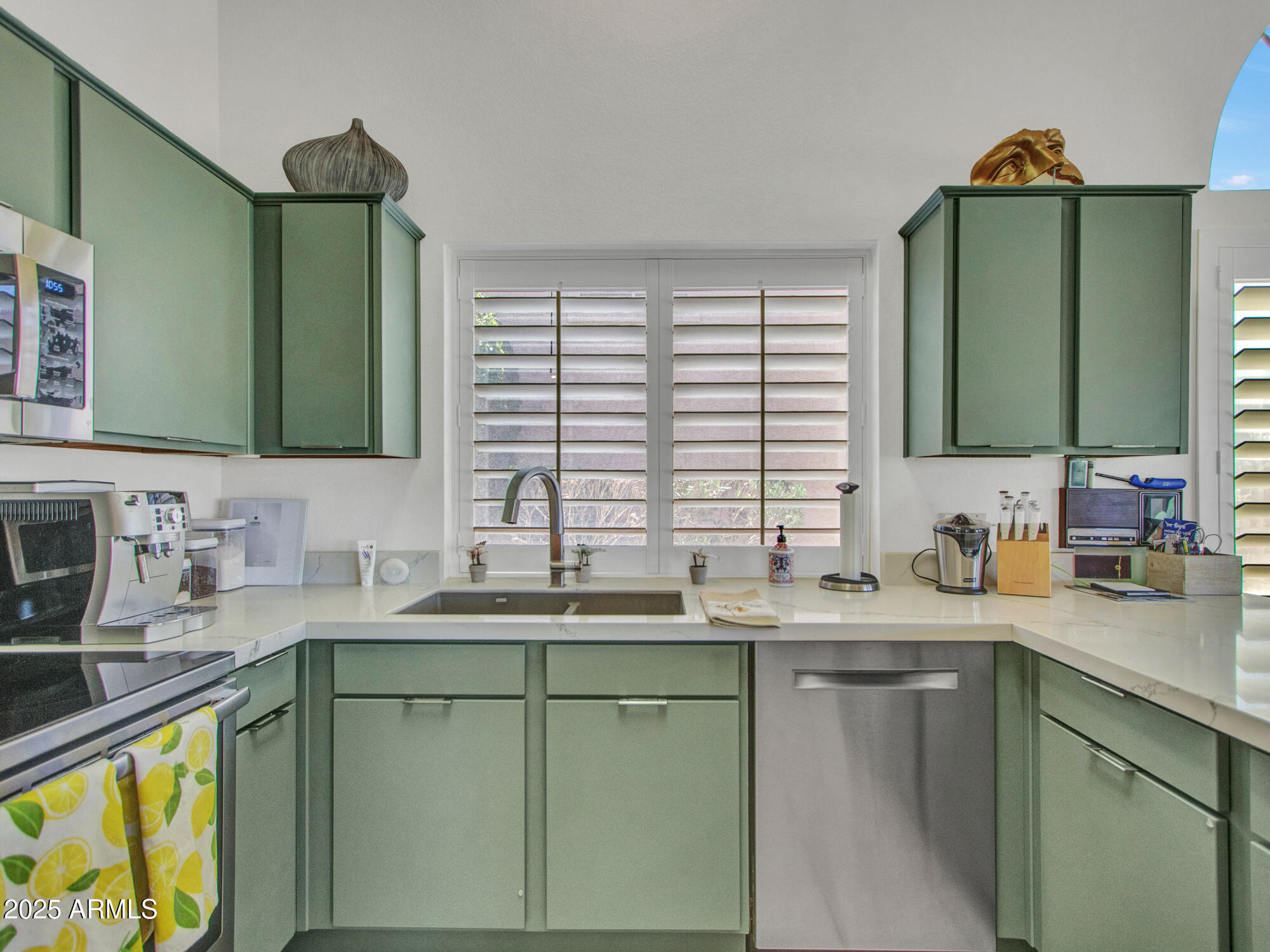 9343 West Escuda Drive Peoria, AZ 85382 - Photo 17 of 51 a kitchen with sink a window and cabinets