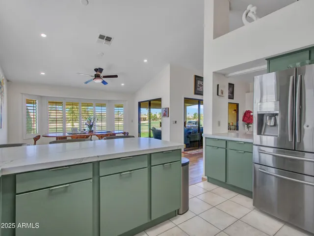a kitchen with sink a window and cabinets