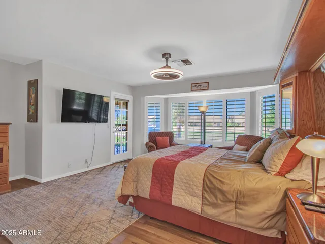 a bedroom with a bed and glass windows