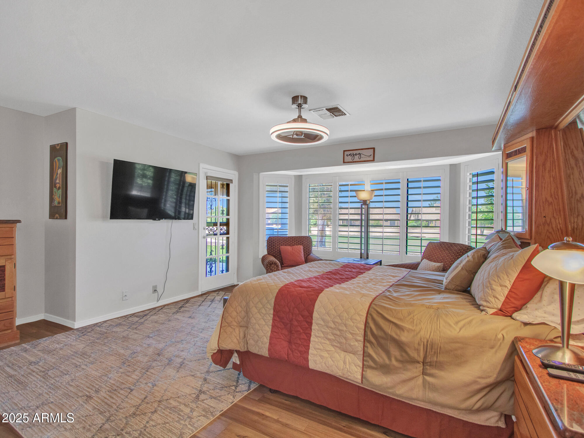 9343 West Escuda Drive Peoria, AZ 85382 - Photo 25 of 51 a bedroom with a large bed and a flat tv screen
