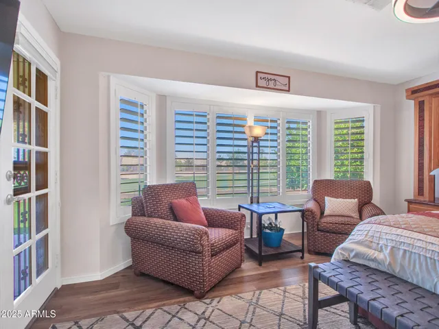 a bedroom with a large bed and a flat tv screen