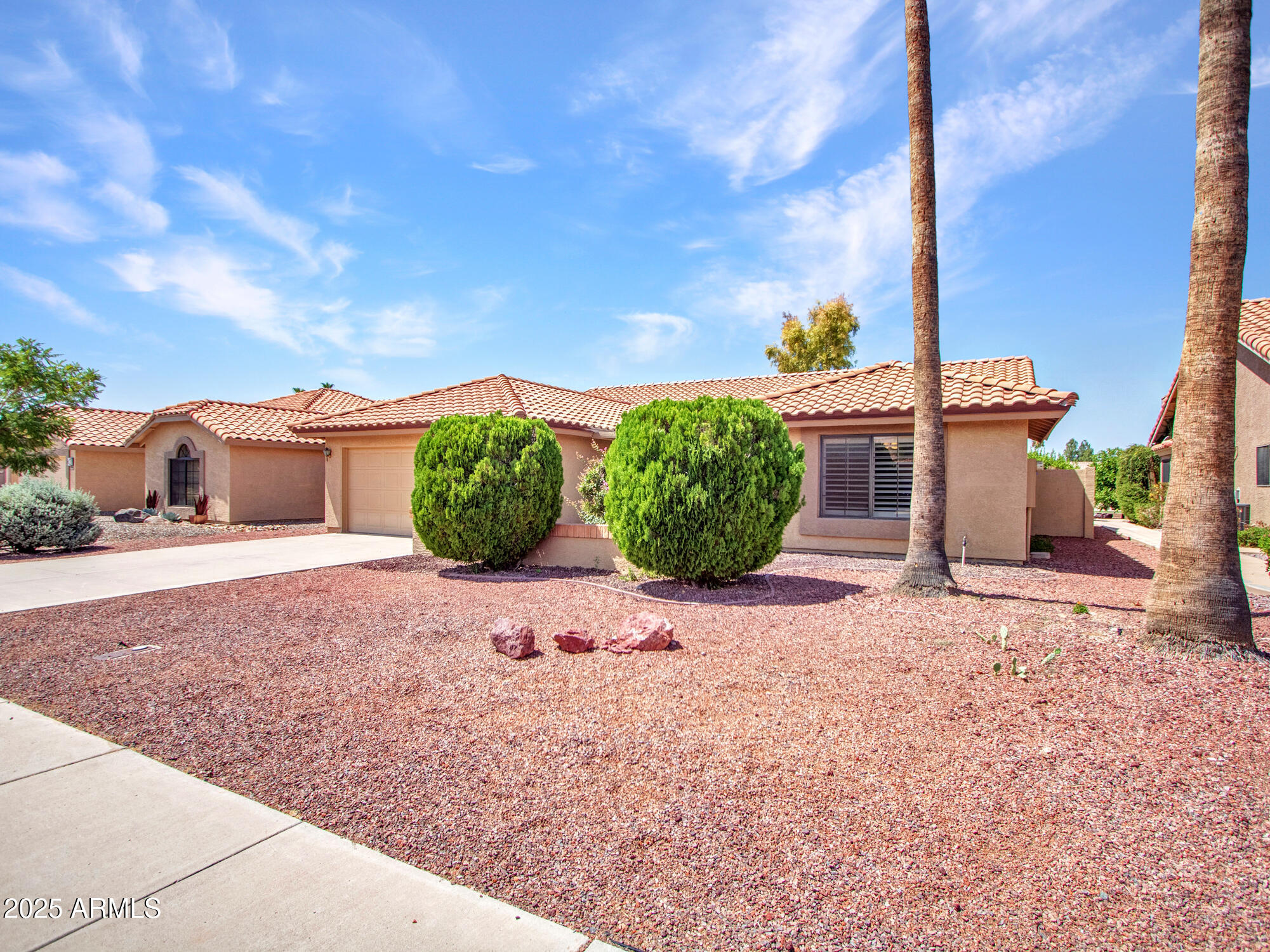 9343 West Escuda Drive Peoria, AZ 85382 - Photo 2 of 51 a view of a street with a house in the background