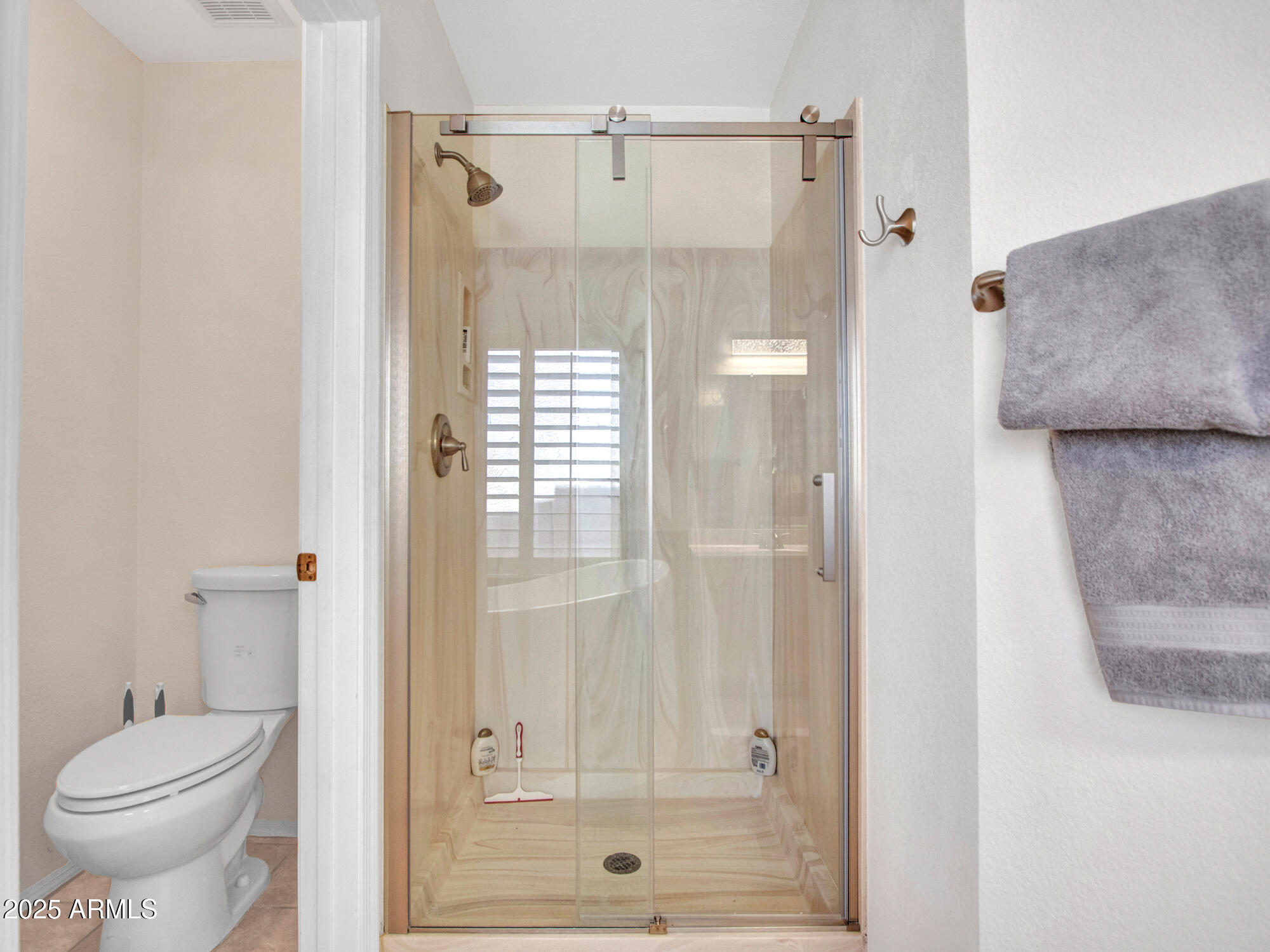 9343 West Escuda Drive Peoria, AZ 85382 - Photo 31 of 51 a bathroom with a shower and a toilet