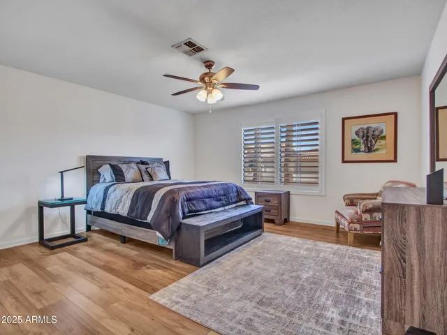 a spacious bathroom with a granite countertop sink mirror and bathtub