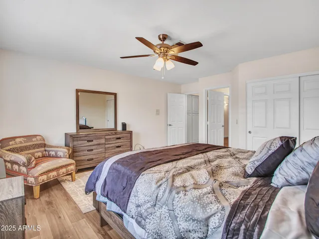 a bedroom with a bed dresser and a window