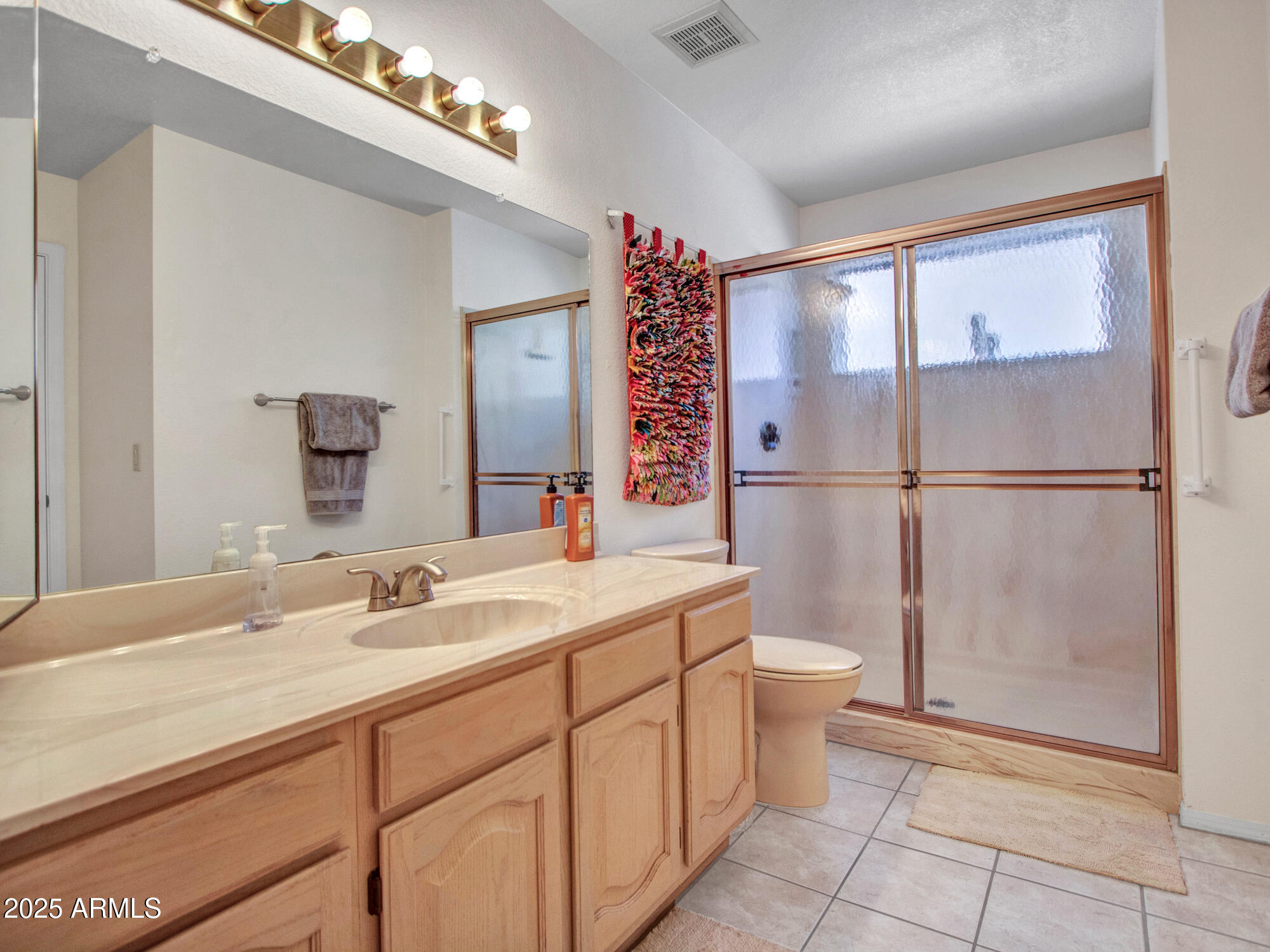 9343 West Escuda Drive Peoria, AZ 85382 - Photo 38 of 51 a bathroom with a toilet sink and mirror