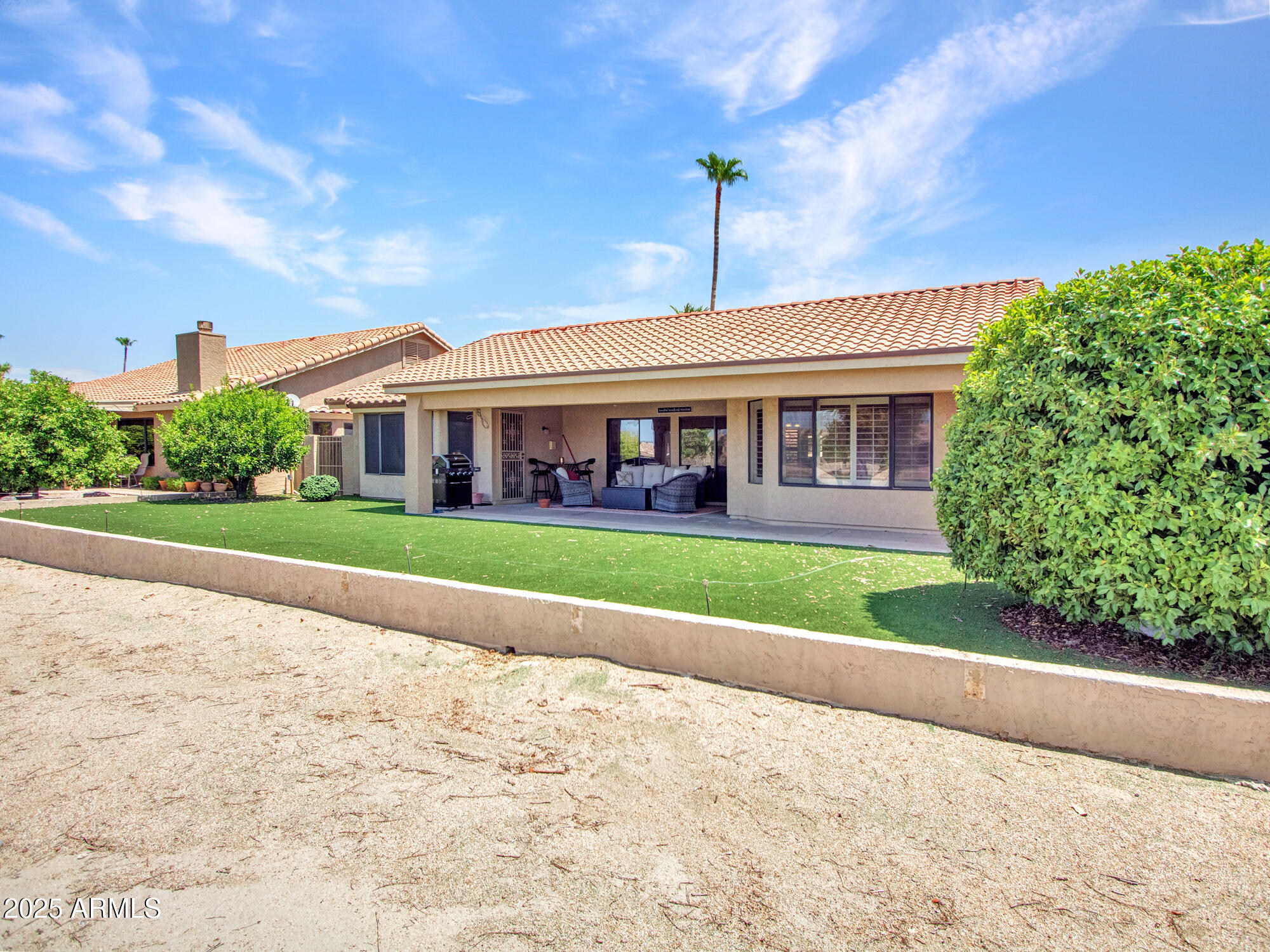 9343 West Escuda Drive Peoria, AZ 85382 - Photo 39 of 51 a front view of a house with a yard and potted plants