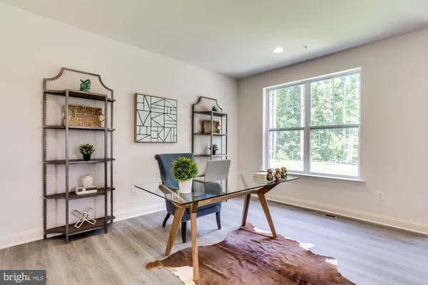 a workspace room with furniture and a window