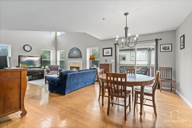 a living room with furniture dining table and a chandelier