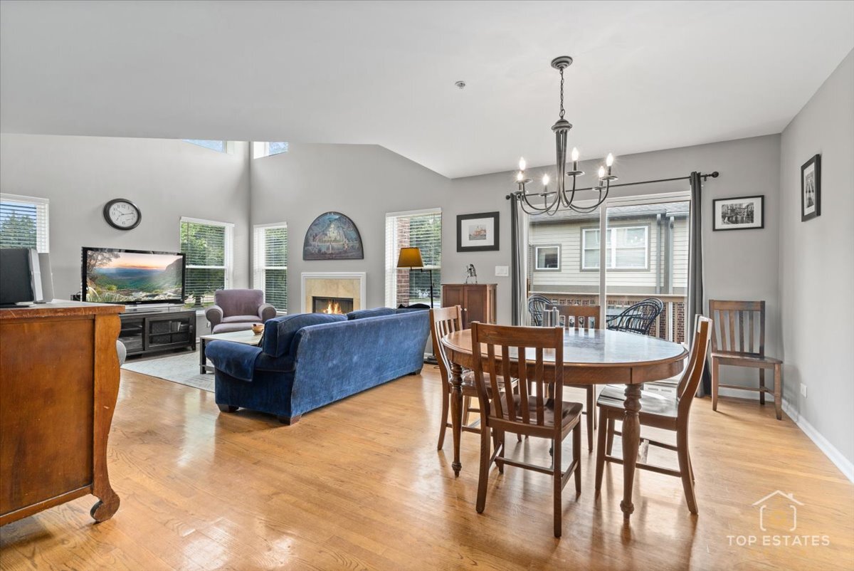 1651 Pauline Circle, Unit 1651 Mundelein, IL 60060 - Photo 14 of 42 a living room with furniture dining table and a chandelier