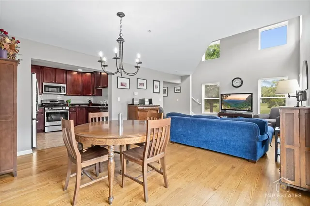 a living room with kitchen island furniture and a chandelier