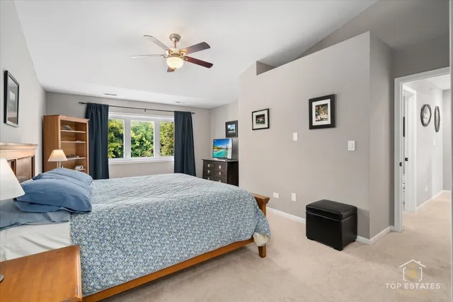 a bedroom with a large bed and a window