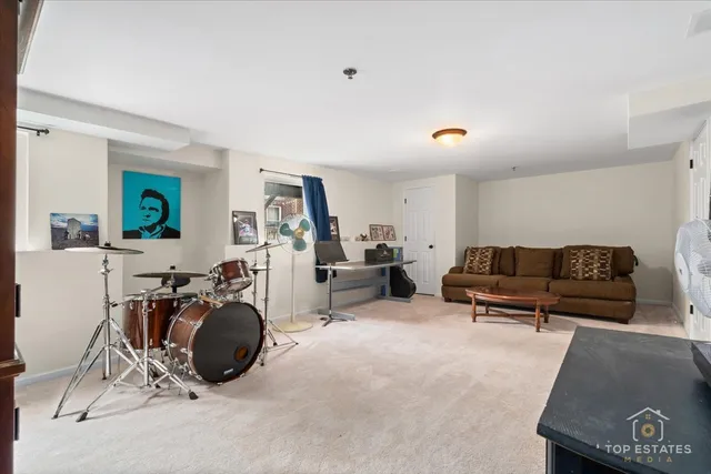 a living room with furniture a flat screen tv and a table
