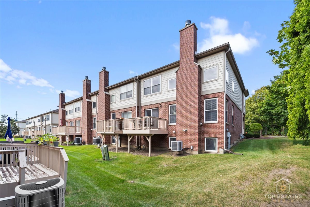 1651 Pauline Circle, Unit 1651 Mundelein, IL 60060 - Photo 35 of 42 a backyard of a house with a garden and barbeque oven