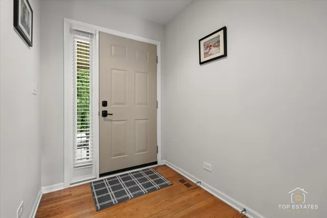 a view of an empty room with a window and a fireplace