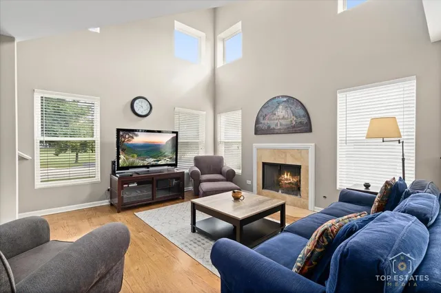 a living room with furniture a fireplace and a flat screen tv