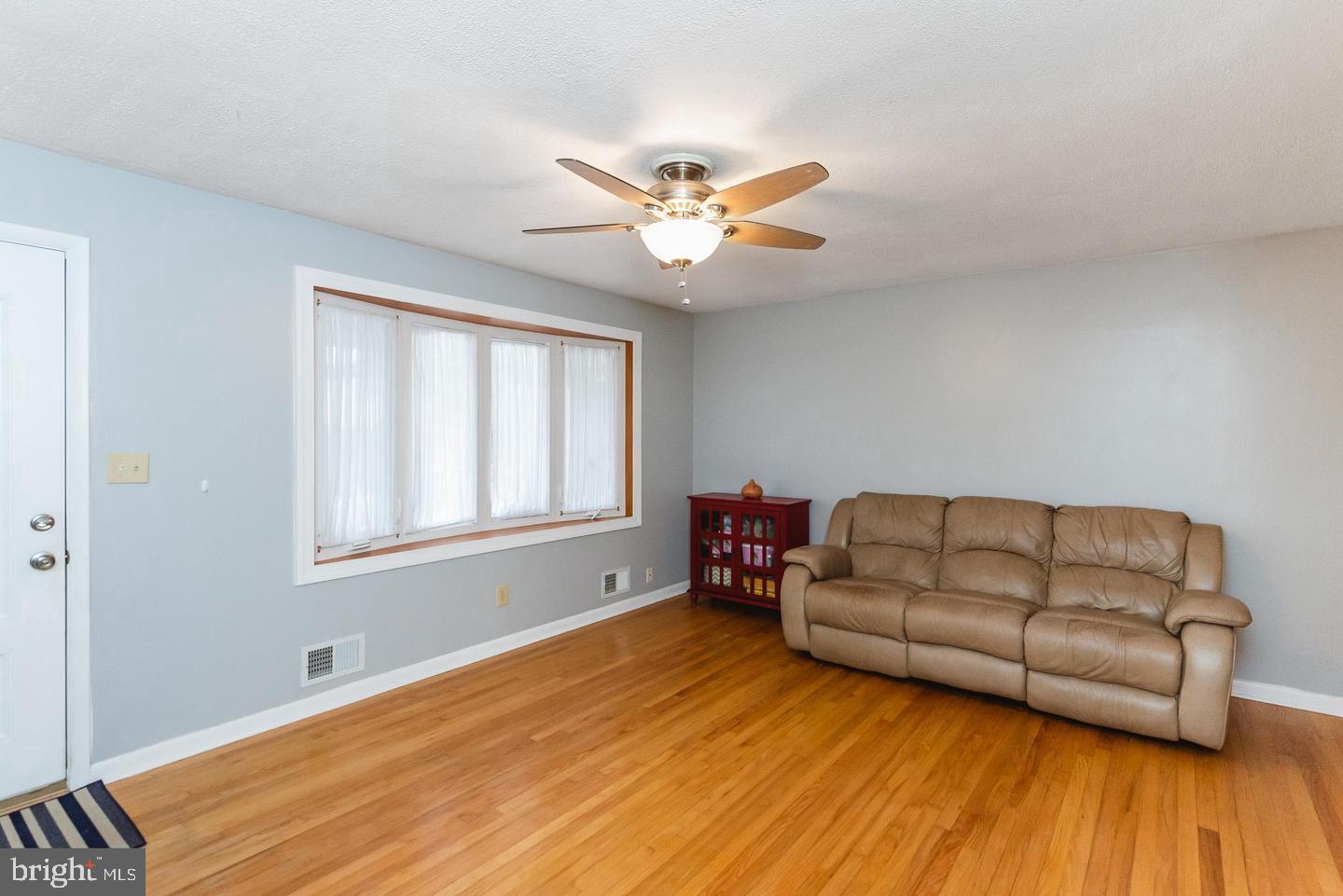 4217 Mispillion Road Nottingham, MD 21236 - Photo 11 of 40 Living room with ceiling fan and quadruple window