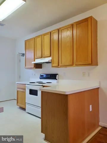 a kitchen with stainless steel appliances granite countertop a sink a stove and a microwave