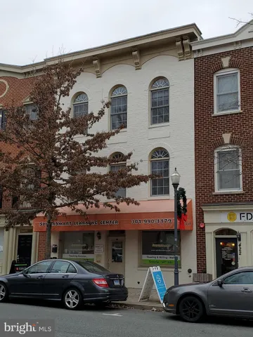 a front view of a house with parking space