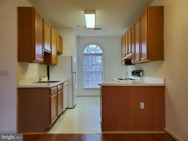 a spacious bathroom with a sink a mirror and a shower