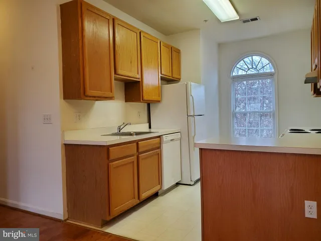 a kitchen with stainless steel appliances granite countertop a sink a stove and a microwave oven