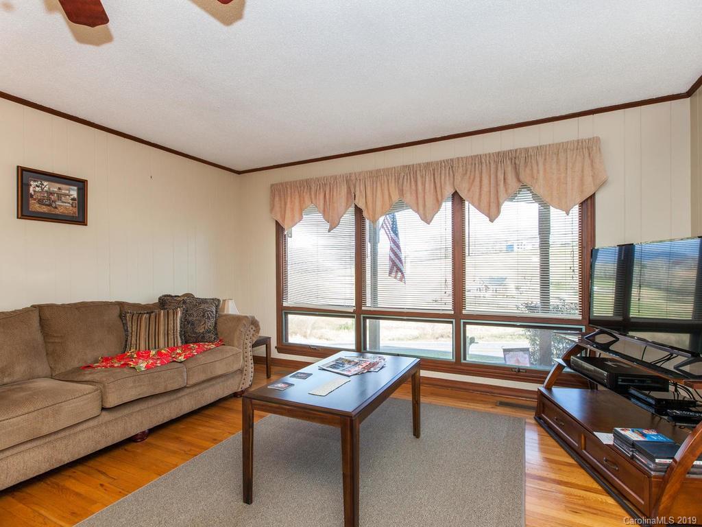 2533 Iron Duff Road Waynesville, NC 28785 - Photo 11 of 35 a living room with furniture and a flat screen tv