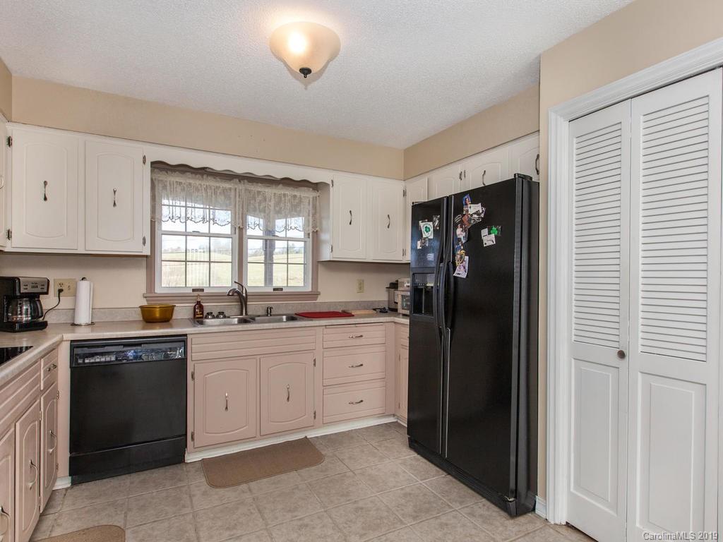2533 Iron Duff Road Waynesville, NC 28785 - Photo 15 of 35 a kitchen with a refrigerator and cabinets