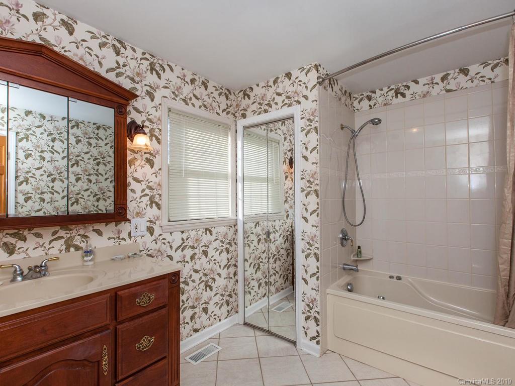 2533 Iron Duff Road Waynesville, NC 28785 - Photo 20 of 35 a bathroom with a bathtub sink and mirror