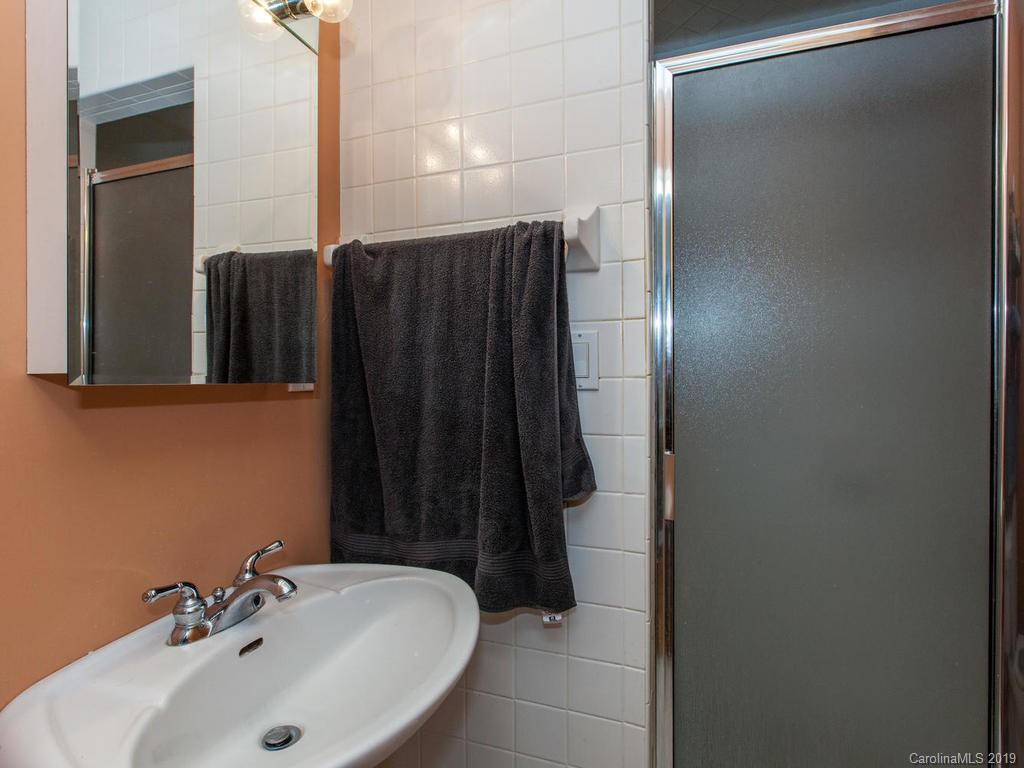 2533 Iron Duff Road Waynesville, NC 28785 - Photo 24 of 35 a bathroom with a sink and mirror