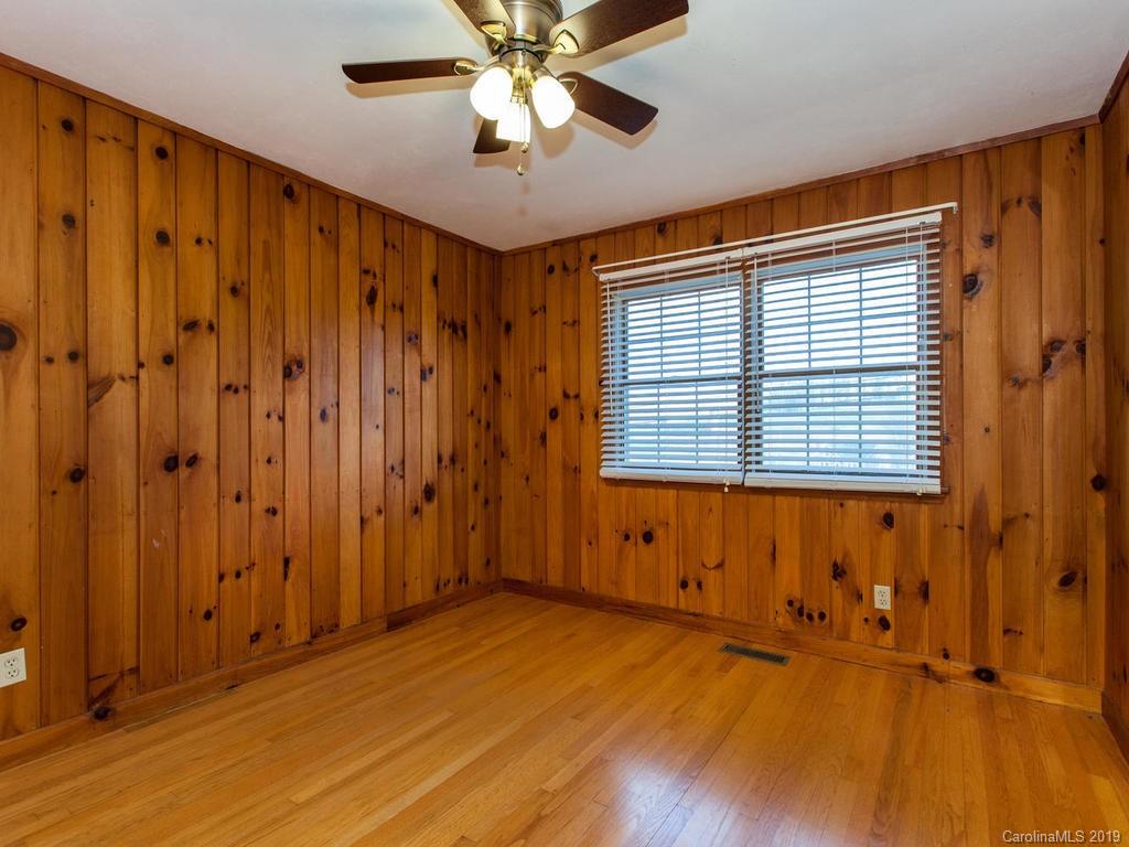 2533 Iron Duff Road Waynesville, NC 28785 - Photo 25 of 35 an empty room with wooden floor and windows