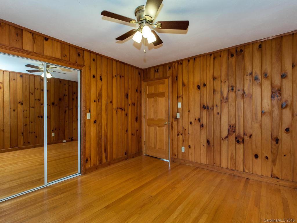 2533 Iron Duff Road Waynesville, NC 28785 - Photo 27 of 35 a view of a livingroom with a chandelier fan and wooden floor